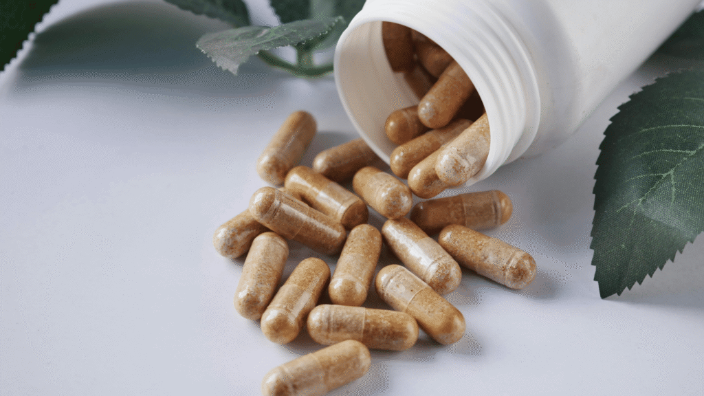 Bottle of HepatoBurn supplement surrounded by natural ingredients like herbs and roots.