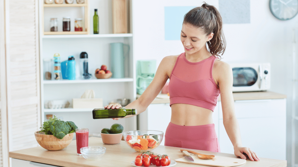 Woman preparing a healthy meal in the kitchen, emphasizing lifestyle factors that support fat burning.

