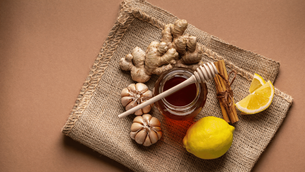 Garlic, lemon, turmeric, and avocado arranged on a white surface to represent natural liver detox foods