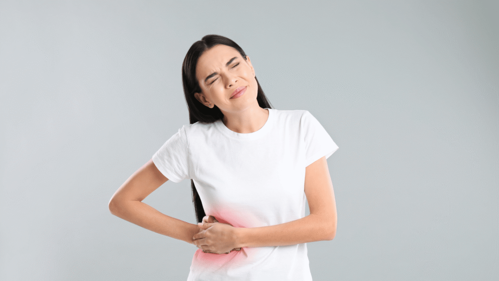 Medical-style illustration of a person holding their side in mild discomfort with abstract liver icons and a question mark above their head.

