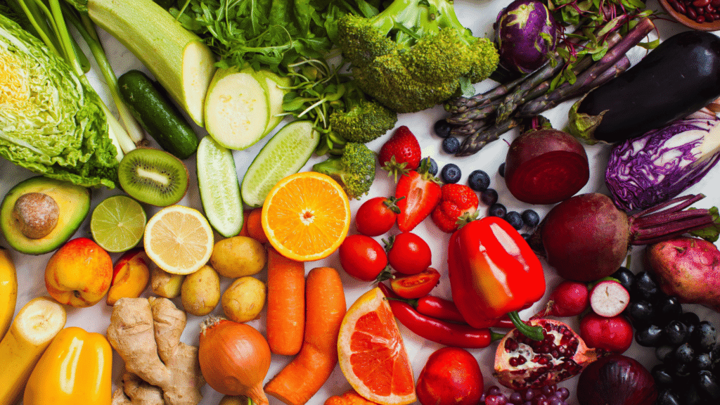 Natural detox ingredients like herbs, fruits, and vegetables displayed on a clean table.