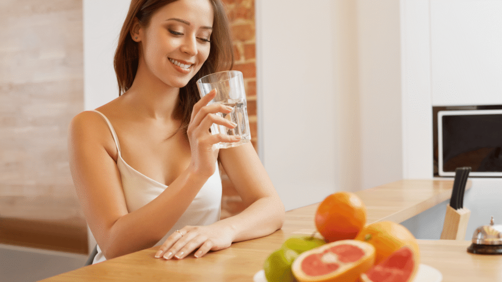 A healthy woman enjoying hydration and wellness, symbolizing balance after liver detox.