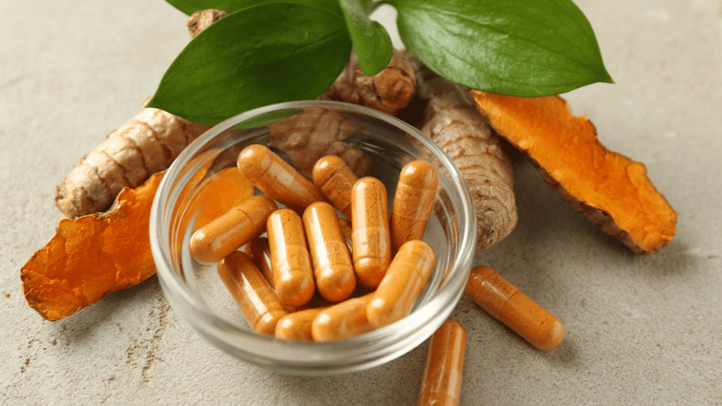 supplement bottle surrounded by milk thistle, green tea, turmeric, and dandelion root on clean white background.