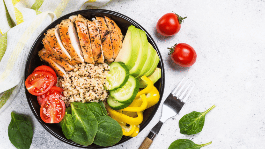 A healthy meal featuring leafy greens, avocado, and lean protein, ideal for supporting natural liver detox through diet.